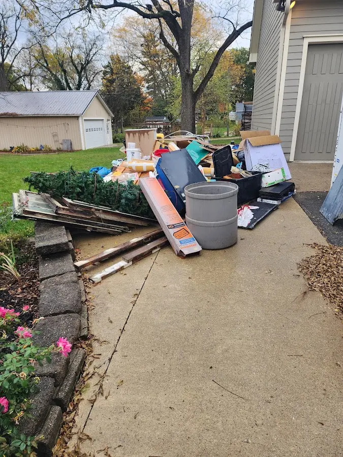 Dumpster being loaded with debris for 10 Yard Dumpster Rental in Munford
